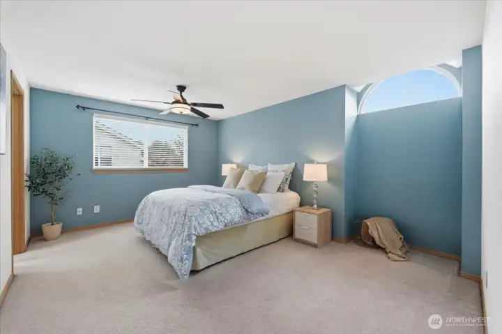 Primary bedroom with bright windows and nook area