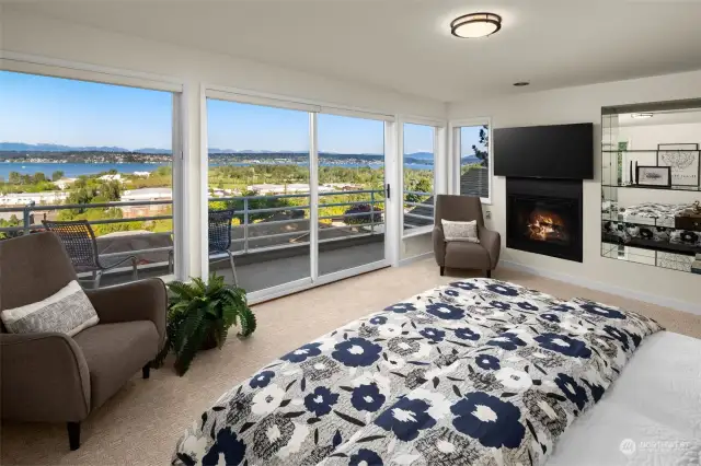 Grand primary suite with stunning views, gas fireplace, AC, walk-in closet, and 5-piece bath.