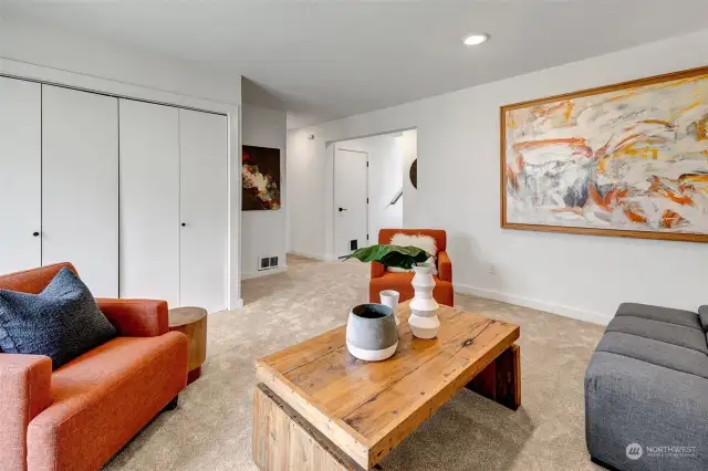 Another angle of the downstairs area featuring a neatly enclosed laundry room—offering a clean, organized space for all your laundry needs.