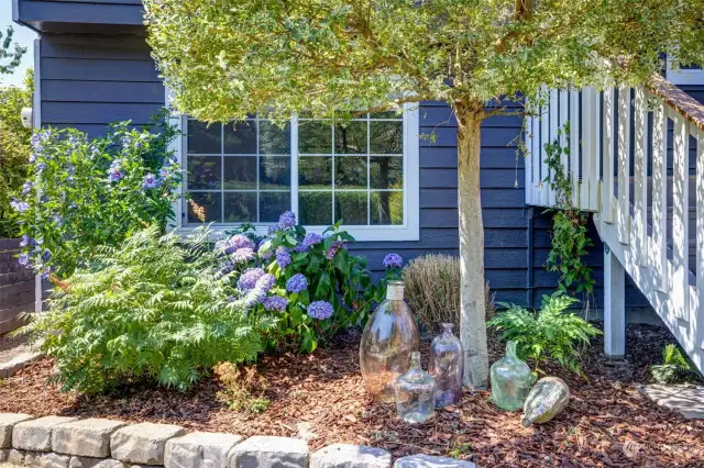 Stunning front landscaping enhances curb appeal with its vibrant and inviting design.