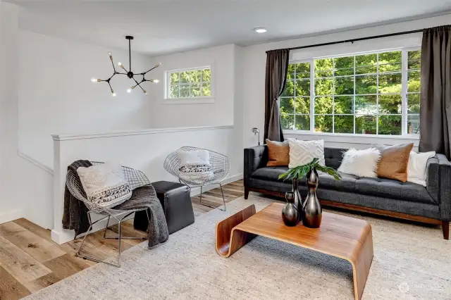 Beautiful living room with expansive windows, bathing the space in abundant natural light and creating a bright, airy atmosphere.