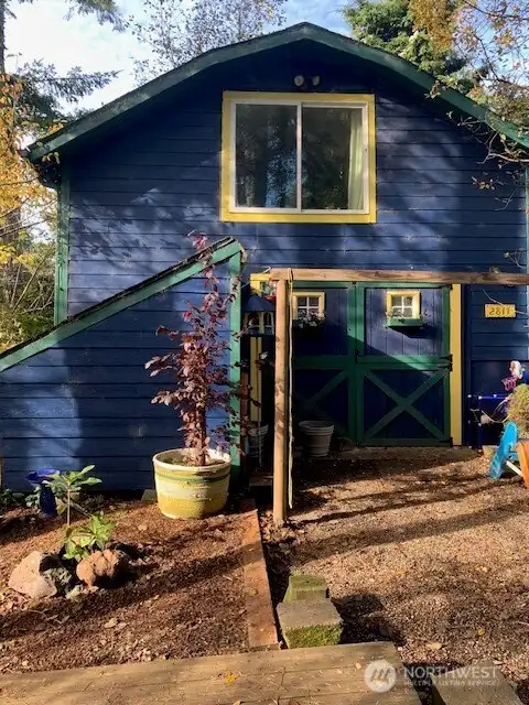 The detached garage with a loft area above and a kitchen/great room area and full bathroom downstairs.