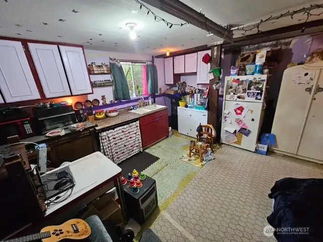 The garage is being used as a kitchen but easily converts back into the full garage.