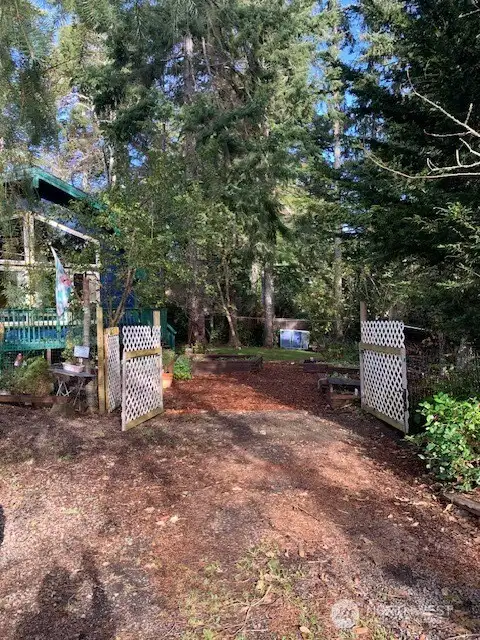 Double gates open to the expansive backyard and entry to the home.
