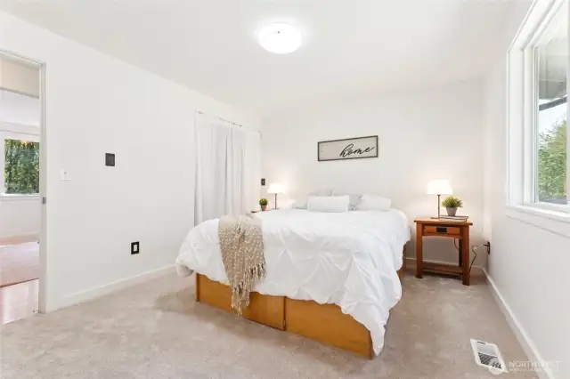 Primary bedroom features dual closets with built ins and an updated bath