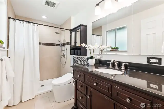 Primary bathroom features walk in shower, granite countertops & a bidet with heated seat
