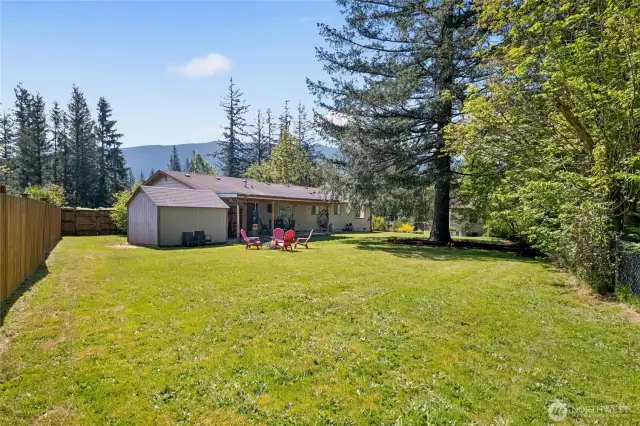 Expansive fenced yard features a covered patio, storage shed & gardening area.   Side yard is also fenced and contains the detached studio/office