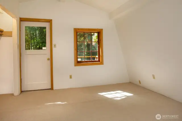 Upper bedroom with closet & balcony access.