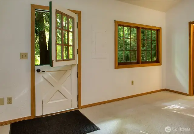 Vaulted ceilings with clerestory windows for natural light in kitchen/dining area.  Dutch door leads to deck.