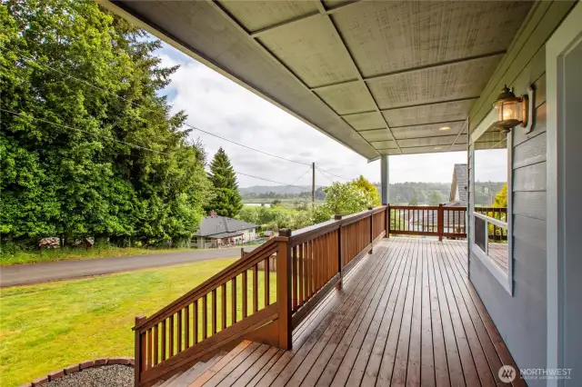 Front porch with a beautiful view of the South Fork of the Willapa River and rolling hills.