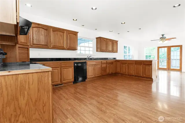 Kitchen with large eat in kitchen space and French doors to back deck