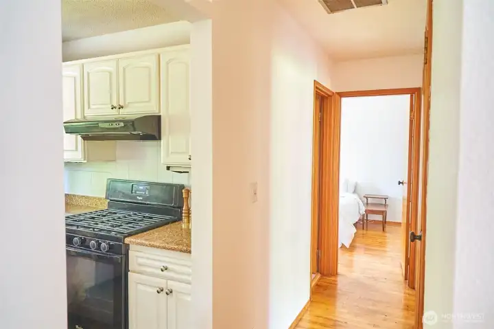 Hallway leads to three bedrooms and bath,