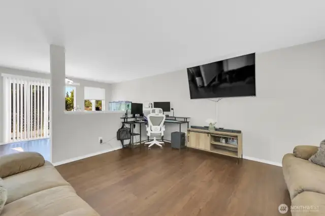 Cozy living room with open concept to dining room and deck view.