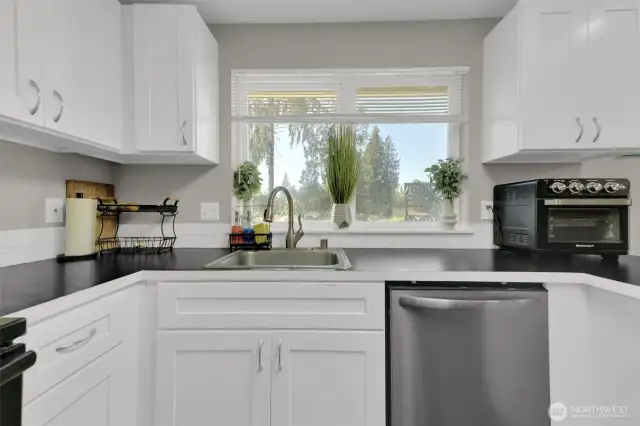 Plenty of counter space and stainless dishwasher in kitchen.