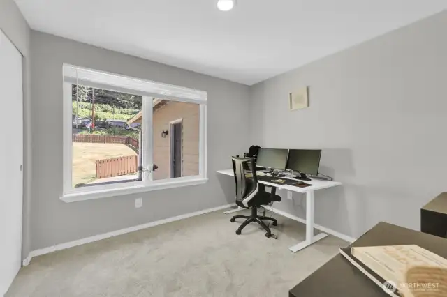 Light and bright bedroom or office with new carpet.