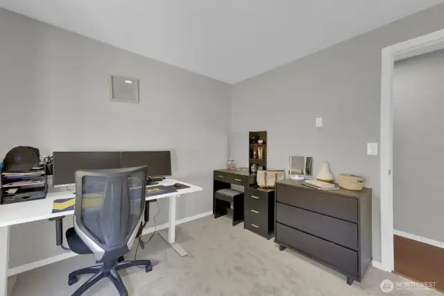 Home office with natural light and new carpet.