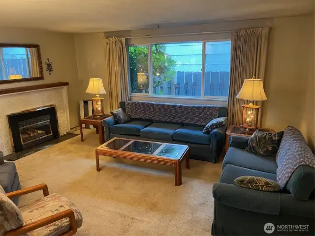 Family room with wood stove and mantel. Extra carpet padding and soft carpet for added comfort.