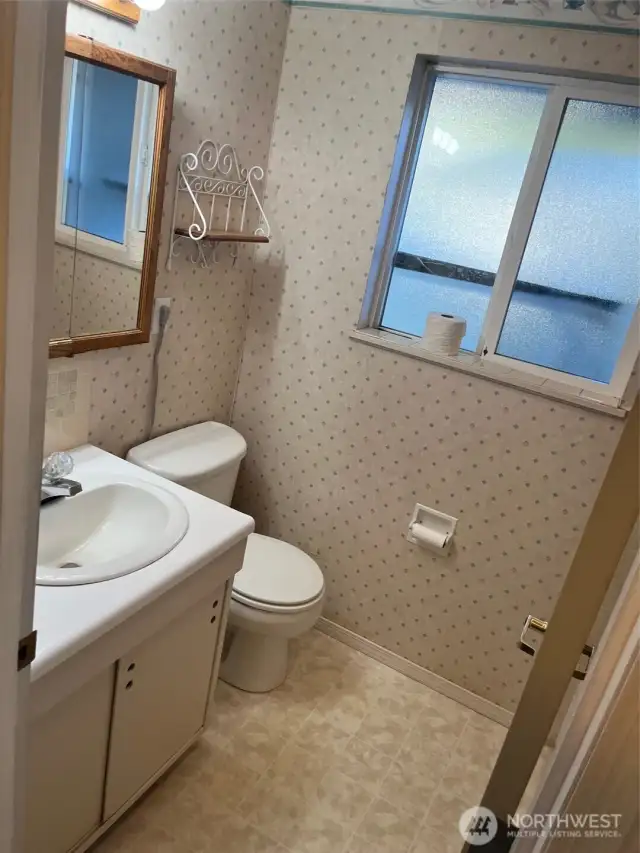 Full bathroom has sink vanity with  medicine cabint and three panel mirror lights above. Toilet is heated with Bidet.