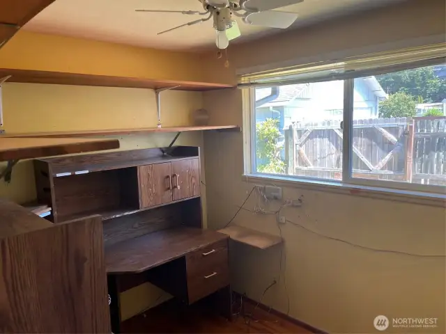 3rd Bedroom if desk removed or Office as currently used. Window overlooks back yard. Ceiling fan and light above.