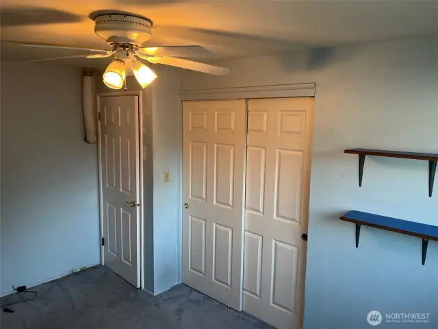 5th Bedroom has 6 panel doors on doorway and closet. Ceiling fan light above. Previously used as sewing room, office, and bedroom.