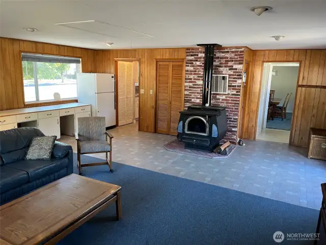 Large living room. Behind wood stove you will find High Effency Furnace and Yard Sprinkler controls on right side and pantry and Gas water hear on left side . Extra Freezer close to entry for kitchen.