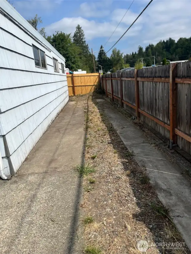 RV/Extra Vehicle parking on East Side of Shop. Shop is 40 ft long and this parking area extends all the way to street which is