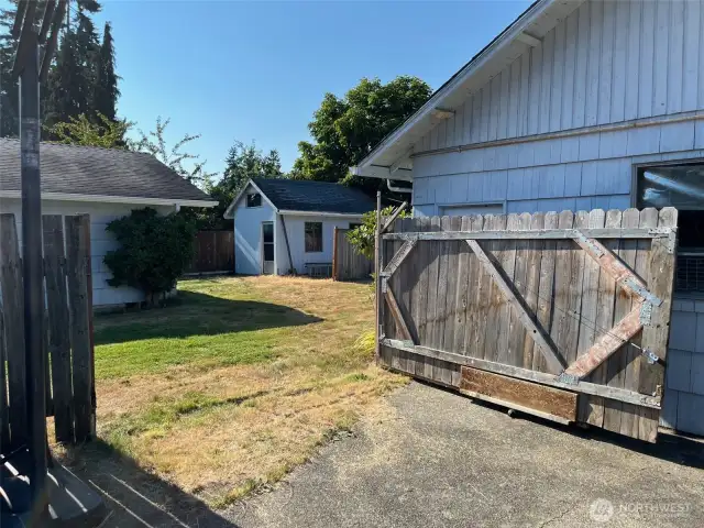 large Gate on wheelsopens to allow access to back yard for secure storage of vehicles or to move large items in and out of yard.