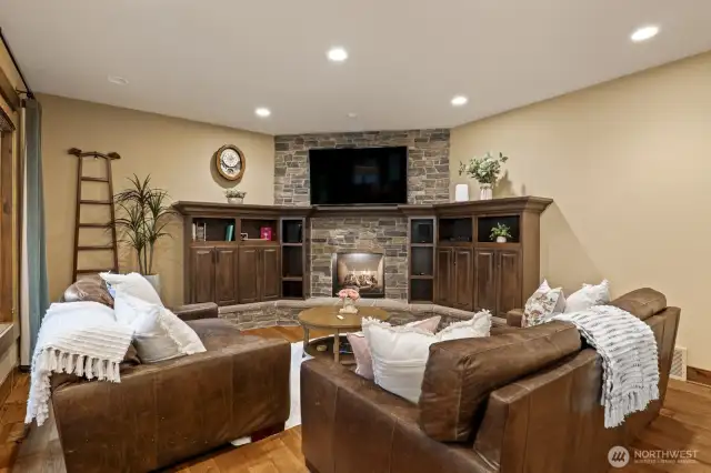 A cozy adjoining family room with a gas fireplace and custom built-ins, seamlessly connecting to the 1600* sq ft outdoor entertaining space.