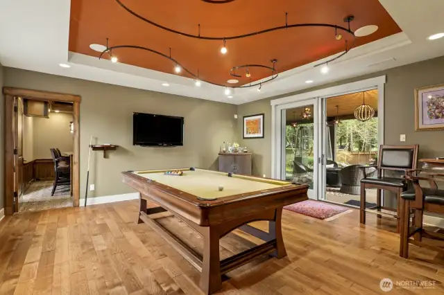 Next to the theater is the billiard room with door to the covered lounge area.