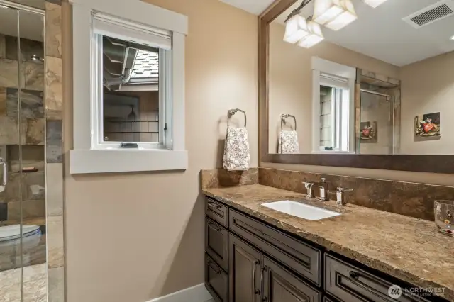 The 3rd en-suite bathroom with slab granite and stone work.