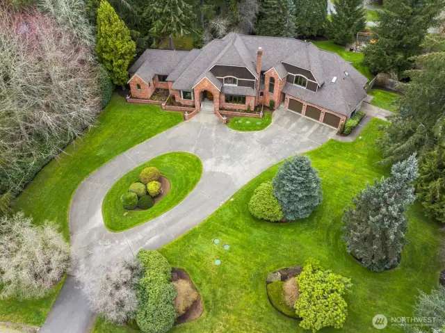 Expansive circular driveway and commanding street presence.