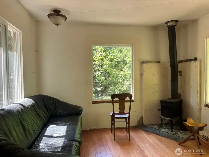 Sunny livingroom with wood stove.