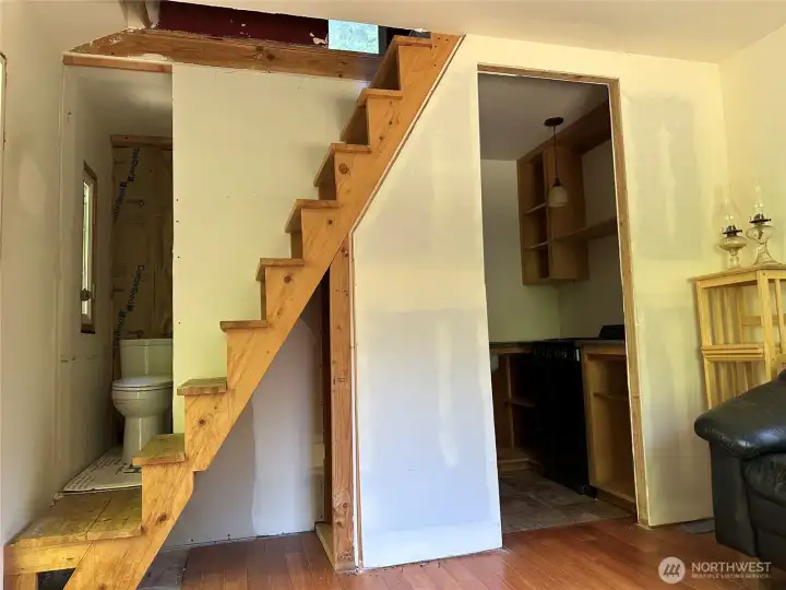 Unfinshed bath room. Basic kitichen. Stairway to upper floor.
