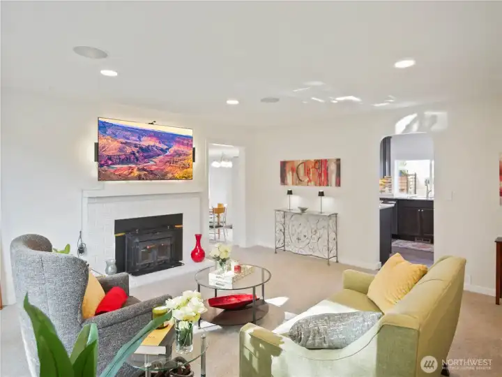 This cozy space features a modern glass-top dining table, sleek chairs, and vibrant wall art.