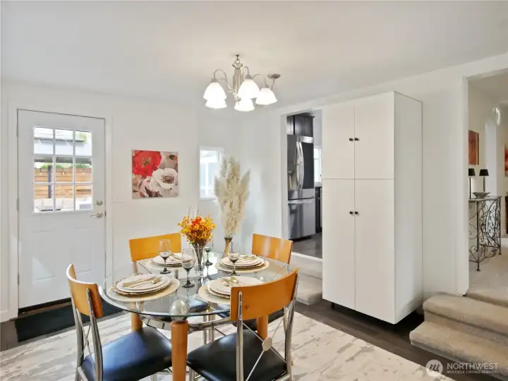 Open dining area with access to kitchen and outdoor space
