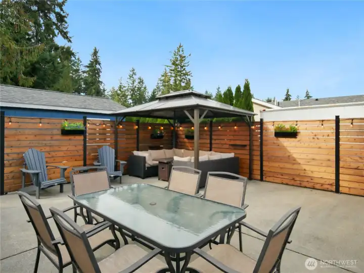 Spacious concrete patio with a cozy gazebo, dining table for six great for entertaining or relaxing.