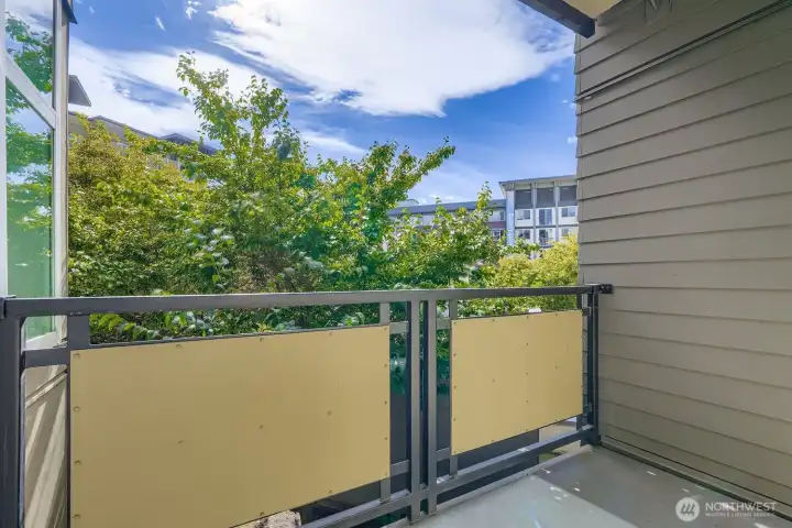 Private deck surrounded by trees.
