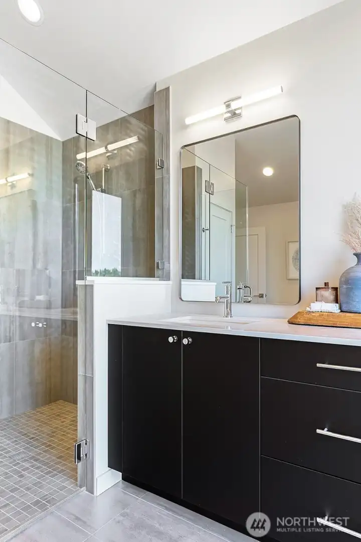 Photos of model home 9752 with similar finishes & floor plan. Another look at the shower and vanity setup—simple, modern, and thoughtfully styled.