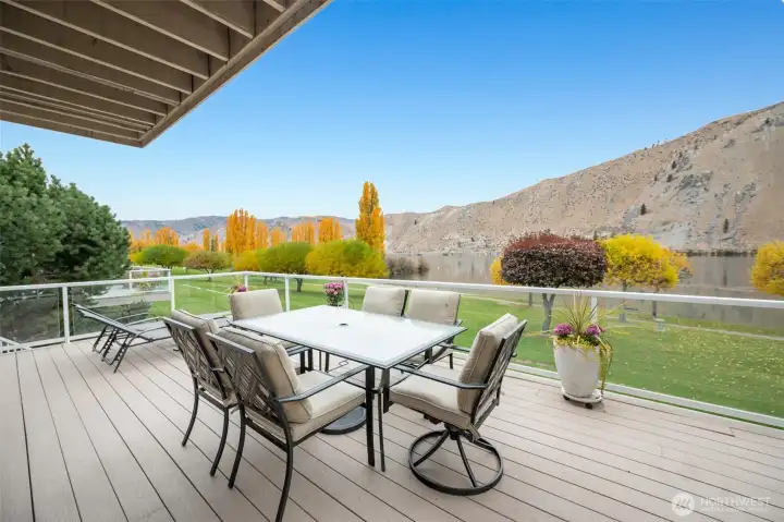 Covered portion of the composite wraparound deck with ample seating space overlooking the Columbia River and landscaped greenspace.