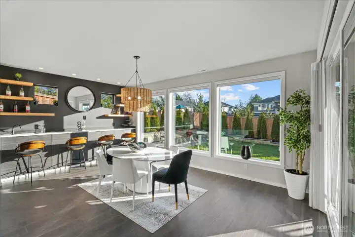 Wet bar and dining room gleaming in natural light