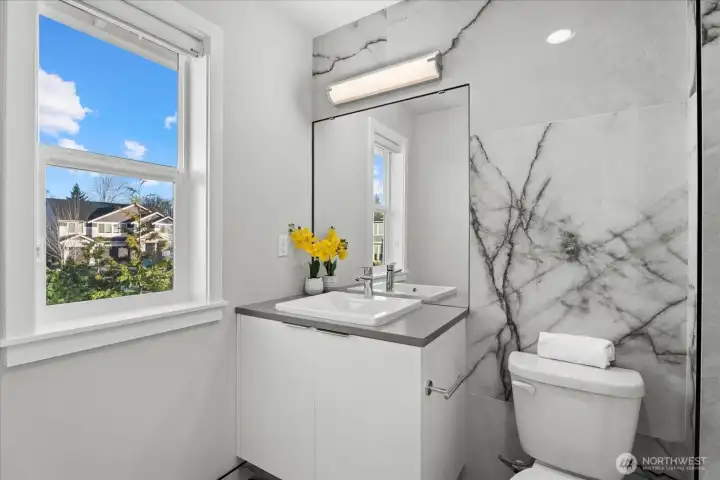 Bedroom #1 en suite with example of custom tile found throughout home