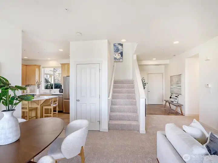 The open living room and dining room with the half bath and coat closet off to your right.