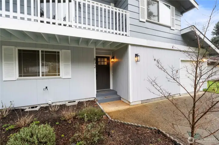 A covered front porch warmly invites you inside.