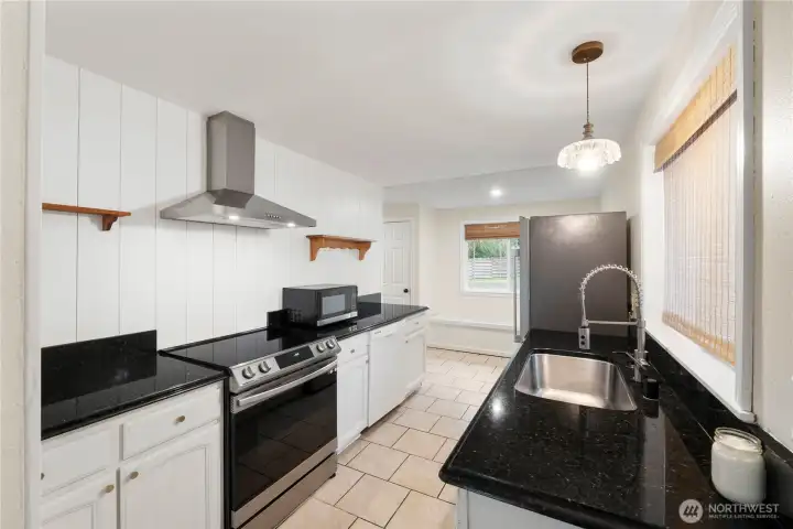 Stunning kitchen with granite counters and stainless-steel appliances.