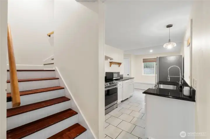 Hardwood floors guide the way up the stairs.