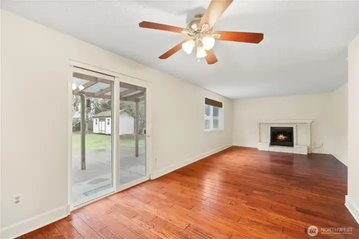 Family room features a wood burning fireplace with brick surround and wood mantle for ambiance and those chilly nights.