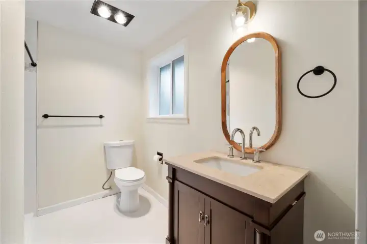 Primary bath with updated vanity and tile floors.