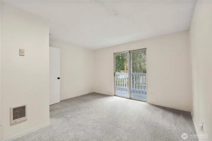 Another view of the bonus room featuring a slider leading to the balcony.