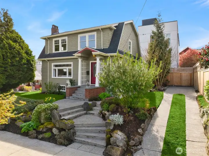 Timeless 1921 Dutch Colonial Revival perched on a prized corner lot on a quiet residential street.