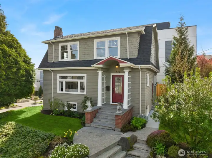 Timeless 1921 Dutch Colonial Revival perched on a prized corner lot on a quiet residential street.